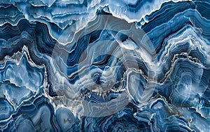 This image captures the natural striations of blue agate, resembling rhythmic ocean waves. The bands of varying blue