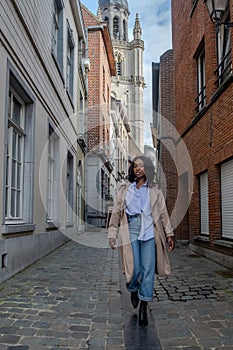 Elegant Woman Strolling in a Historical European Lane photo