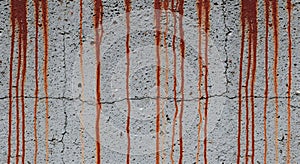 Rust streaks and cracks on weathered concrete wall