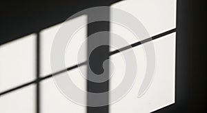 Sunlight casting geometric window shadows on a white wall