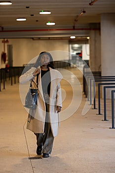 Urban Commute: Young Black Woman in Stylish Winter Attire photo