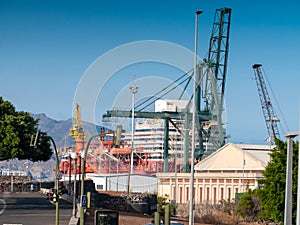 Image of cargo port terminal at ocean harbour with floating docks and hevy lifting crane