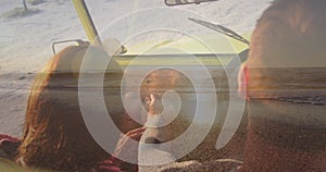 Image of caucasian couple in car on beach over seascape