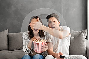 Image of caucasian uptight family sitting on sofa at home with p