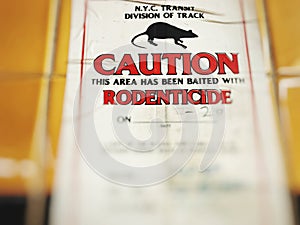 Image of caution this area has been baited with rodenticide sign .