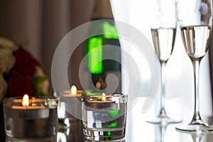 Image of champagne with candles on the bedside table