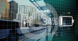 Image of charge status data on electric vehicle interface, over sped up train passing station photo