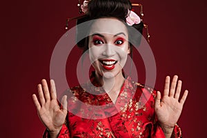 Image of cheerful geisha woman in traditional japanese kimono smiling