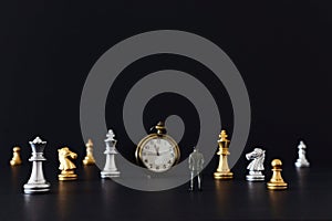 Image of chess game. Businessman looking at vintage clock and pawns, competition, strategy, leadership and success concept