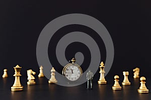 Image of chess game. Businessman looking at vintage clock and pawns, competition, strategy, leadership and success concept