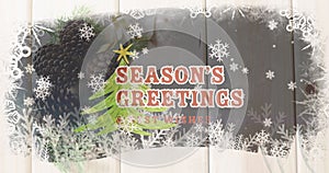 Image of christmas greetings text over christmas tree and decorations