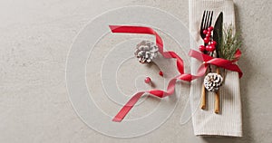 Image of christmas place setting with cutlery and copy space on grey background