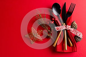 Image of christmas place setting with cutlery and copy space on red background