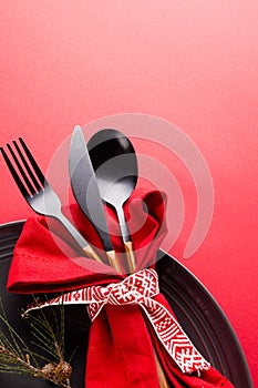 Image of christmas place setting with cutlery and copy space on red background