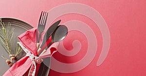 Image of christmas place setting with cutlery and copy space on red background