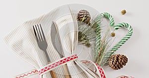 Image of christmas place setting with cutlery and copy space on white background