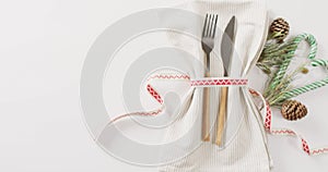 Image of christmas place setting with cutlery and copy space on white background