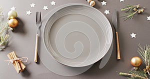 Image of christmas place setting with cutlery on grey background