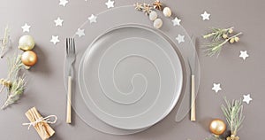 Image of christmas place setting with cutlery on grey background