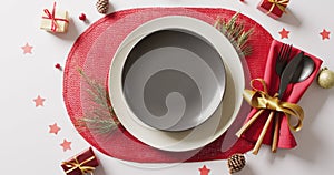 Image of christmas place setting with cutlery on white background