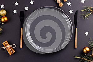 Image of christmas place setting with plate and cutlery on black background