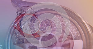 Image of clock over hand holding clock