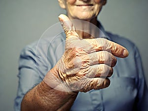 image of the close shot of someone hand showing thumbs up.