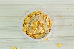 Image Close up Cornflakes cereal breakfast in white bowl on woo