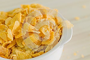 Image Close up Cornflakes cereal breakfast in white bowl on woo