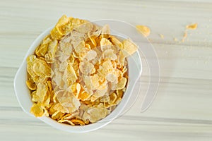 Image Close up Cornflakes cereal breakfast in white bowl on woo