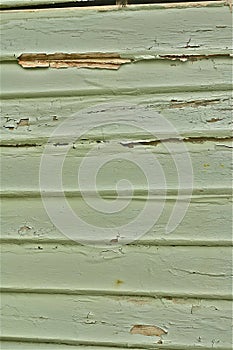 Green paint peeling timber weatherboard wall photo