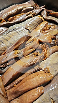 close up stack of the fish rue on the tray.