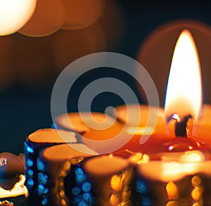 Image of close up of traditional lit indian candle on dark background