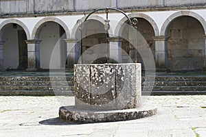 Old stone water well in Caminha, Portugal photo