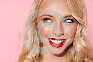 Image closeup of beautiful fashion woman wearing red lipstick smiling and looking aside at copyspace