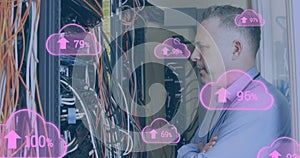 Image of clouds with uploading over caucasian man checking servers photo