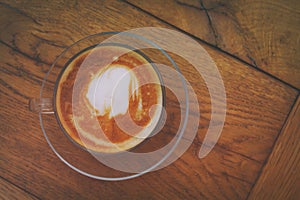 image of coffee cup over old wooden table