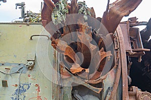 Image of a collection of rusted industrialmechanical components, featuring a large metal structure with an opening on