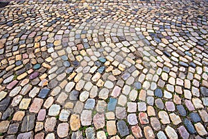 Colorful cobblestone pattern on old European cobbled street