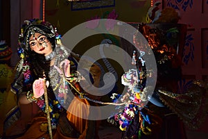 Image of colorful gods dancing in an ISKCON temple in Delhi photo