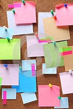 Image of colorful sticky notes on cork bulletin board