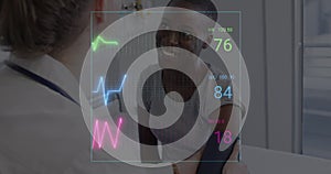 Image of colourful cardiographs over happy diverse patient and doctor taking pressure photo
