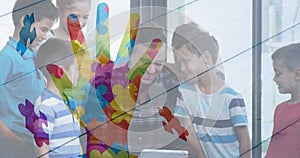 Image of colourful hand over kids and man using electronic devices