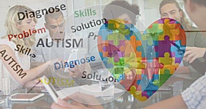 Image of colourful puzzle pieces, autism text over business colleagues with electronic devices