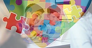 Image of colourful puzzle pieces and autism text over kids friends using electronic devices