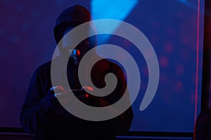 Computer hacker with mobile phone