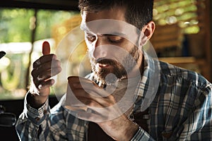 Image of concentrated barista man making coffee while working in cafe or coffeehouse outdoor