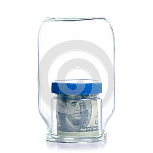 The image of the concept of the financial and banking system of a large Bank absorbs a small Bank in the form of two glass jars