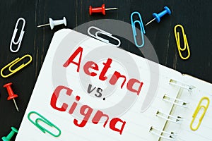 The image contains the inscription Aetna vs. Cigna on a notepad sheet