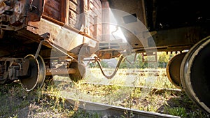 Image of coupler connecting and pairing two cargo train cars on railroad at susnet